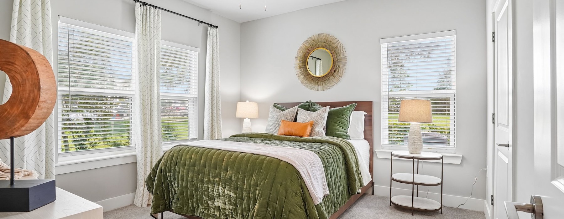 a bedroom with a bed and windows