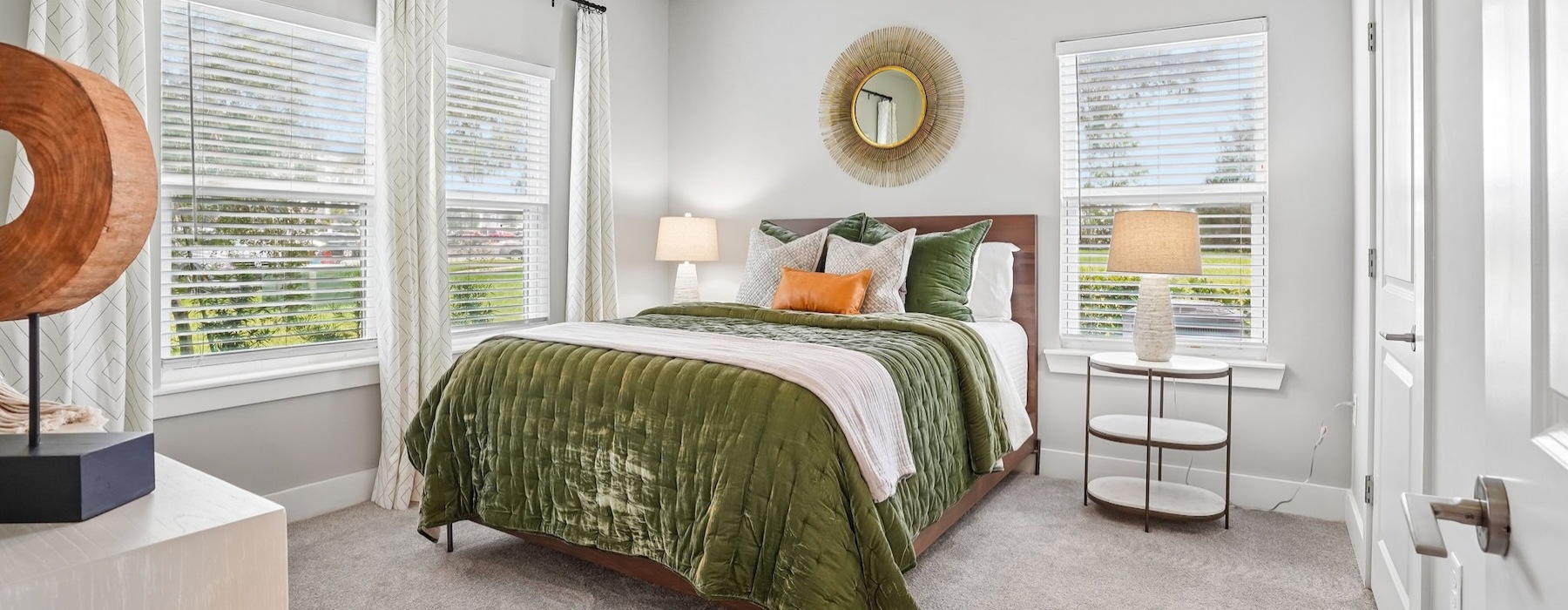 a bedroom with a bed and windows