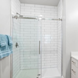a bathroom with a glass shower and sink