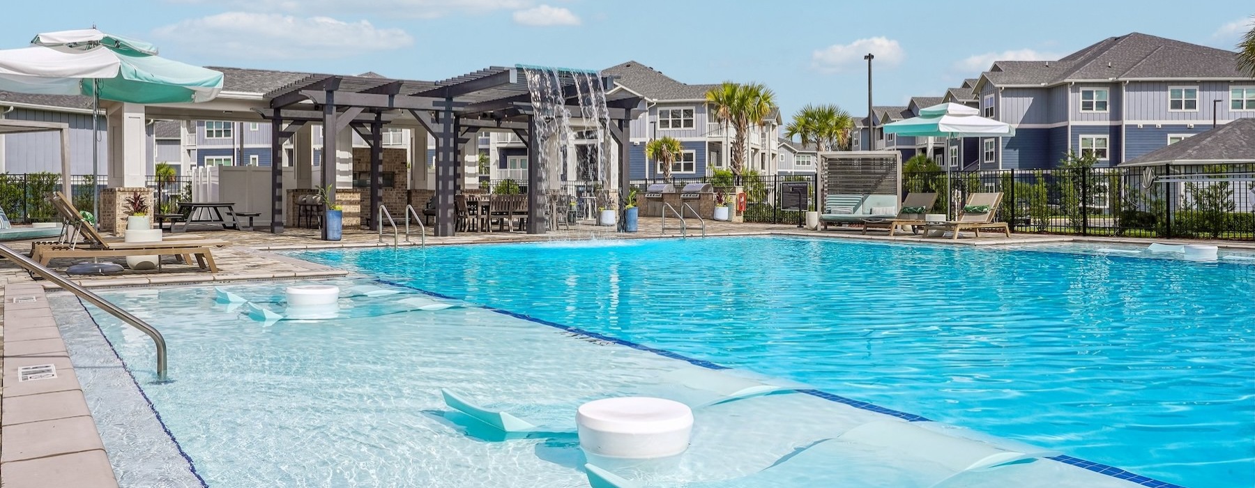 a swimming pool with buildings in the background