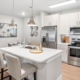a kitchen with white cabinets and a table