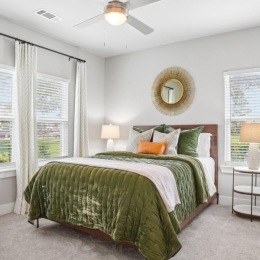 a bedroom with a bed and windows