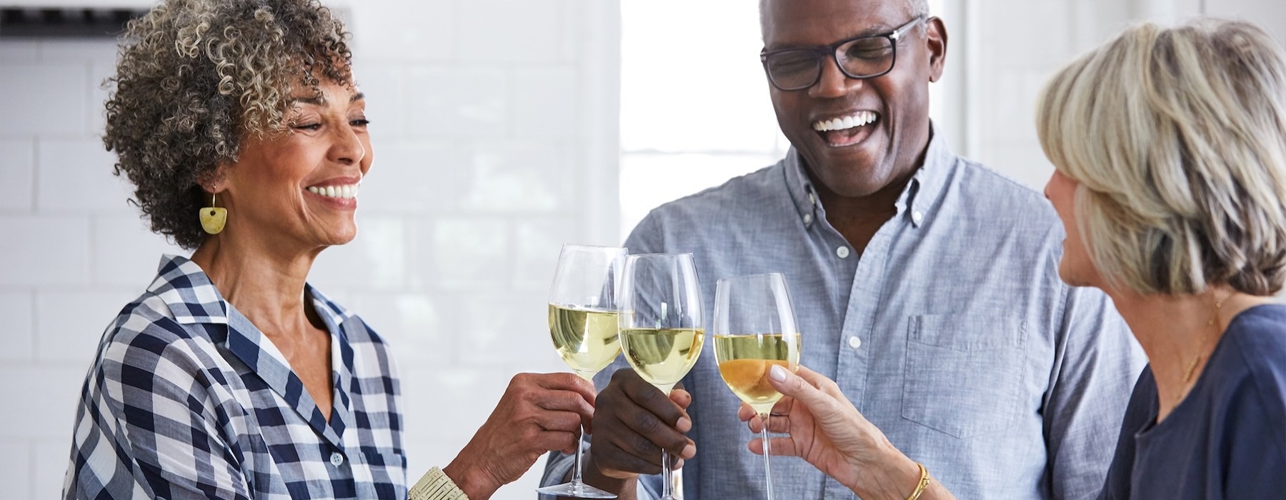 a few people toasting wine glasses